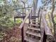 Unique staircase leads up to the wooden deck nestled among lush, mature trees at 506 Fairington Dr, Summerville, SC 29485