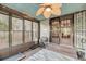 Sunroom featuring a brick floor, ceiling fan, exercise equipment, and screened windows at 506 Fairington Dr, Summerville, SC 29485