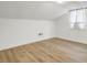 Attic bedroom with neutral walls, new wood-look floors, and a window at 509 Hill St, Moncks Corner, SC 29461