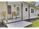 Back porch features wood floors, ceiling supports and two rocking chairs at 509 Hill St, Moncks Corner, SC 29461