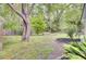 Private backyard featuring a tranquil setting with mature trees, bench, and landscaping at 509 Hill St, Moncks Corner, SC 29461