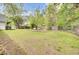 Spacious backyard showcasing a peaceful seating area surrounded by mature trees and lush greenery at 509 Hill St, Moncks Corner, SC 29461
