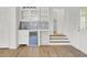 A bar area that includes white cabinetry, shelving, a beverage refrigerator and hard surface floors at 509 Hill St, Moncks Corner, SC 29461