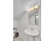 Bright bathroom features a modern pedestal sink, new mirror, and updated lighting at 509 Hill St, Moncks Corner, SC 29461