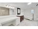 Elegant bathroom with a vanity, soaking tub, and marble-look tile at 509 Hill St, Moncks Corner, SC 29461