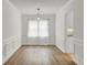 Inviting dining area with wood floors, wainscoting, bright natural light, and modern pendant lighting at 509 Hill St, Moncks Corner, SC 29461