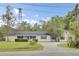 Well-maintained single-story home featuring a cozy front porch, fresh landscaping, and driveway at 509 Hill St, Moncks Corner, SC 29461