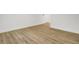 Close-up of the new wood-look flooring, baseboards and neutral walls at 509 Hill St, Moncks Corner, SC 29461