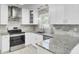 Modern kitchen featuring stainless appliances, granite countertops, designer backsplash, and custom cabinetry at 509 Hill St, Moncks Corner, SC 29461