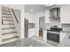 Updated kitchen equipped with modern appliances, granite counters, convenient access to living areas and stairwell at 509 Hill St, Moncks Corner, SC 29461
