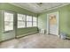 Enclosed sun room with a tile floor, lots of windows, light green walls and a white ceiling fan at 509 Hill St, Moncks Corner, SC 29461