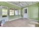 Enclosed sun room with a tile floor, lots of windows, light green walls and a white ceiling fan at 509 Hill St, Moncks Corner, SC 29461