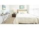 Bright bedroom featuring a cozy bed, side table, and window with natural light at 5520 Bowmore Blvd, Ravenel, SC 29470