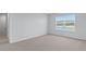 Bedroom with neutral carpet and a window overlooking the community lake at 5520 Bowmore Blvd, Ravenel, SC 29470