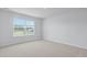 Spacious bedroom featuring neutral carpet, a double window and view of the fenced backyard at 5520 Bowmore Blvd, Ravenel, SC 29470