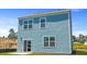 Rear exterior elevation of the two-story home with blue siding at 5520 Bowmore Blvd, Ravenel, SC 29470