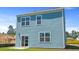 Rear exterior elevation of the two-story home with blue siding at 5520 Bowmore Blvd, Ravenel, SC 29470