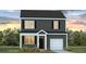 Charming two-story home with black siding, white trim and a well-manicured lawn at 5520 Bowmore Blvd, Ravenel, SC 29470