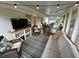 Relaxing back porch features a comfortable sofa, outdoor seating, TV and decorative string lights at 640 Semaht St, Charleston, SC 29412