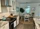 Eat-in kitchen features shaker cabinets, granite countertops, modern appliances, and a light and airy dining area at 640 Semaht St, Charleston, SC 29412
