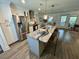 This kitchen offers a large island with a breakfast bar, stainless steel appliances, and shaker cabinets at 640 Semaht St, Charleston, SC 29412