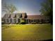 Charming brick home with a manicured lawn and a pop of color from the front door at 805 Horne St, Saint George, SC 29477