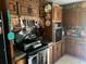 Rustic kitchen with wooden cabinets, brick accents, and functional cooking setup at 805 Horne St, Saint George, SC 29477