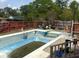 Backyard swimming pool requiring maintenance surrounded by a wooden fence and greenery at 805 Horne St, Saint George, SC 29477