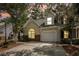 Charming home featuring a one-car garage, well-maintained lawn, and beautiful landscaping during dusk at 8739 Grassy Oak Trl, North Charleston, SC 29420