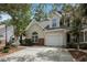 Charming home featuring a one-car garage, well-maintained lawn, and beautiful landscaping at 8739 Grassy Oak Trl, North Charleston, SC 29420