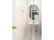 Small half bath features a pedestal sink and an oval mirror at 8739 Grassy Oak Trl, North Charleston, SC 29420