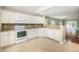 Modern kitchen featuring white appliances, granite countertops, and tile flooring at 8739 Grassy Oak Trl, North Charleston, SC 29420