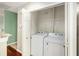 Inside laundry room featuring a newer washer and dryer unit with wire shelving at 8739 Grassy Oak Trl, North Charleston, SC 29420