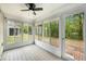Bright sunroom featuring tiled flooring, numerous windows, and access to the backyard and patio area at 8739 Grassy Oak Trl, North Charleston, SC 29420
