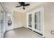 Cozy sunroom with tiled floors, ceiling fan, and multiple doors and windows for enjoying the outdoors at 8739 Grassy Oak Trl, North Charleston, SC 29420