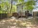Spacious backyard featuring a wooden deck, partial fencing, and a tranquil wooded backdrop at 8810 Gilston Ln, North Charleston, SC 29420