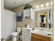 Bathroom features a shower with a curtain, toilet, sink with vanity, and a mirrored medicine cabinet at 8810 Gilston Ln, North Charleston, SC 29420