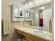 Bathroom featuring a large vanity, a sink, a mirror, ample lighting, and a white-walled shower at 8810 Gilston Ln, North Charleston, SC 29420