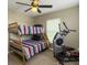 A bedroom with a bunk bed and exercise machine, plus a lighted ceiling fan for comfortable living at 8810 Gilston Ln, North Charleston, SC 29420