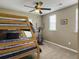 Bedroom featuring bunk beds, neutral-toned walls, a lighted ceiling fan, and natural light from windows at 8810 Gilston Ln, North Charleston, SC 29420