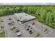 Aerial view of a modern commercial building with ample parking and lush green surroundings at 8810 Gilston Ln, North Charleston, SC 29420