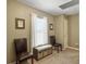 Well-lit hallway with seating and wall decor, providing a comfortable transitional area at 8810 Gilston Ln, North Charleston, SC 29420