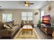 Inviting living room with comfortable seating, ceiling fan, and a serene entertainment area at 8810 Gilston Ln, North Charleston, SC 29420