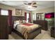 Main bedroom features a wooden bed frame, ample closet space, and TV for relaxing after a long day at 8810 Gilston Ln, North Charleston, SC 29420