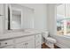 Bathroom with white cabinets, quartz countertop, mirror and natural light at 96 French Garden Cir, Summerville, SC 29486