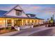 Beautiful lakeside clubhouse exterior featuring a covered porch, brick walkway, and professional landscaping at 96 French Garden Cir, Summerville, SC 29486