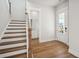 Entryway with wood floors leading to staircase, half bath and front door at 96 French Garden Cir, Summerville, SC 29486