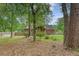 The backyard view, showcasing the home's brick exterior, screened porch, privacy fence, and lush foliage at 104 Leighton Ct, Summerville, SC 29485