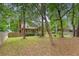 A view of the home's backyard with a chimney, a privacy fence, and a screened-in porch at 104 Leighton Ct, Summerville, SC 29485