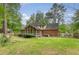 Expansive backyard with lush greenery, showcasing the home's rear exterior with a charming screened porch at 104 Leighton Ct, Summerville, SC 29485